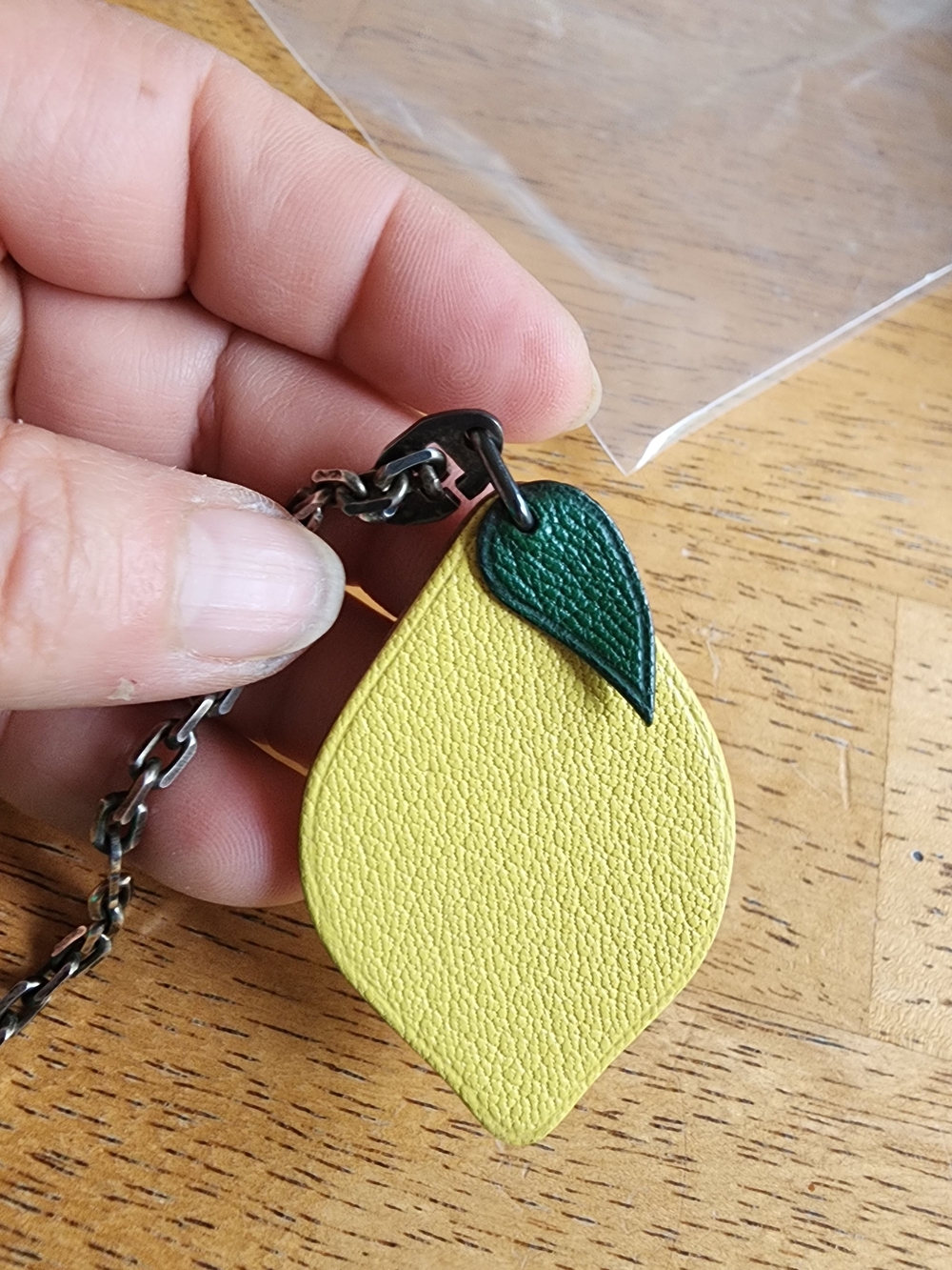 Hermès leather lemon bag charm featuring a green leaf. - Picture 8 of 10